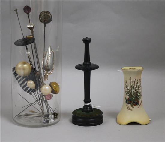 A collection of hatpins, two hatpin stands, one Carlton Ware, one treen and a velvet evening bag